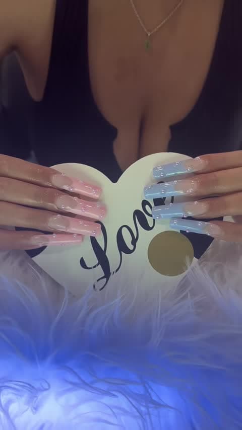 Long square nails with pink and blue tips and pearl-like accents