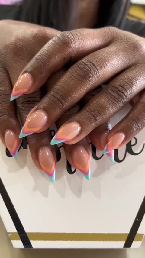 Pointed French tips with mint, pink and orange chevrons